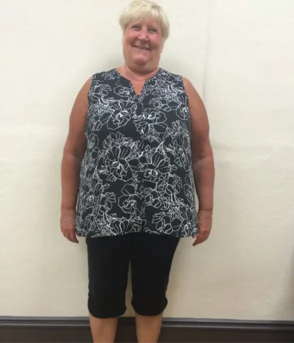Smiling woman in a floral top.